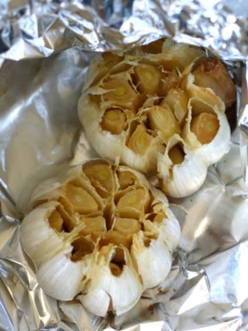 heads of roasted garlic on foil