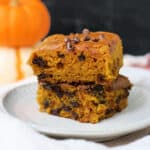 gluten free pumpkin bars on a white plate with chocolate chips