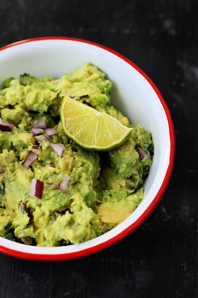 homemade guacamole with a slice of lime