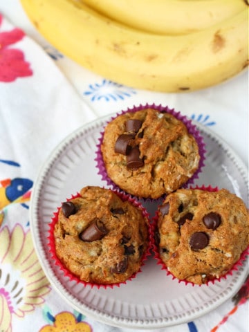 gluten free banana chocolate chip muffins on a white plate