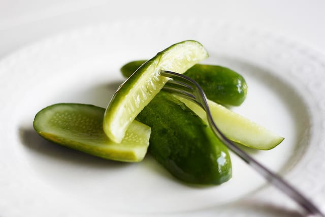 refrigerator dill pickle spears on a white plate