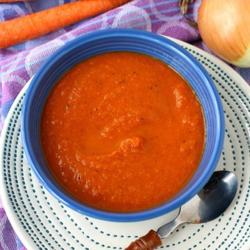 tomato carrot soup in a blue bowl