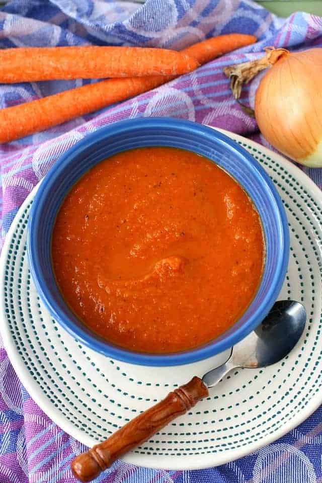 tomato carrot soup in a blue bowl