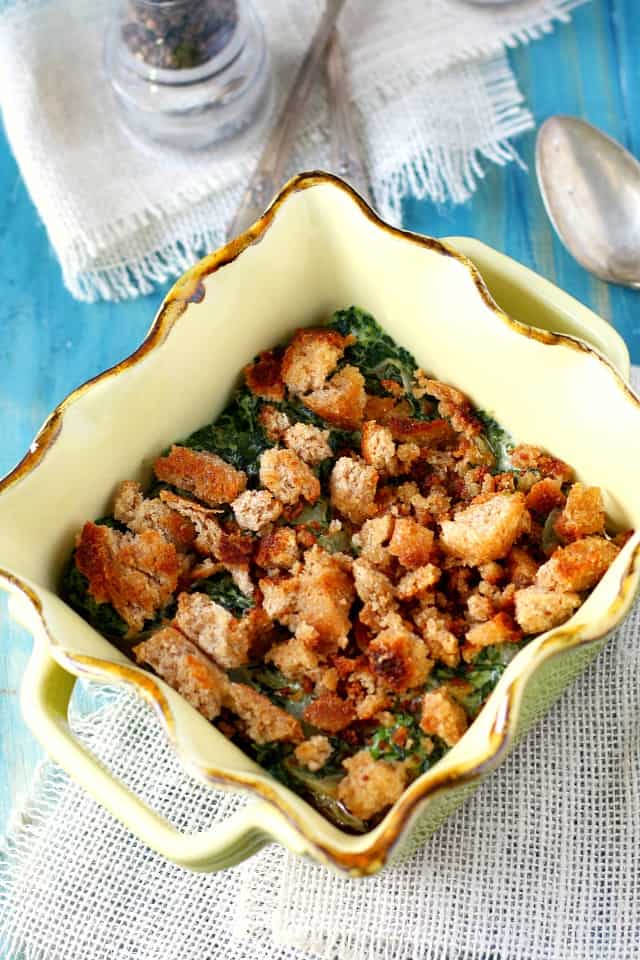 creamed spinach gratin with gluten free breadcrumbs in a casserole dish