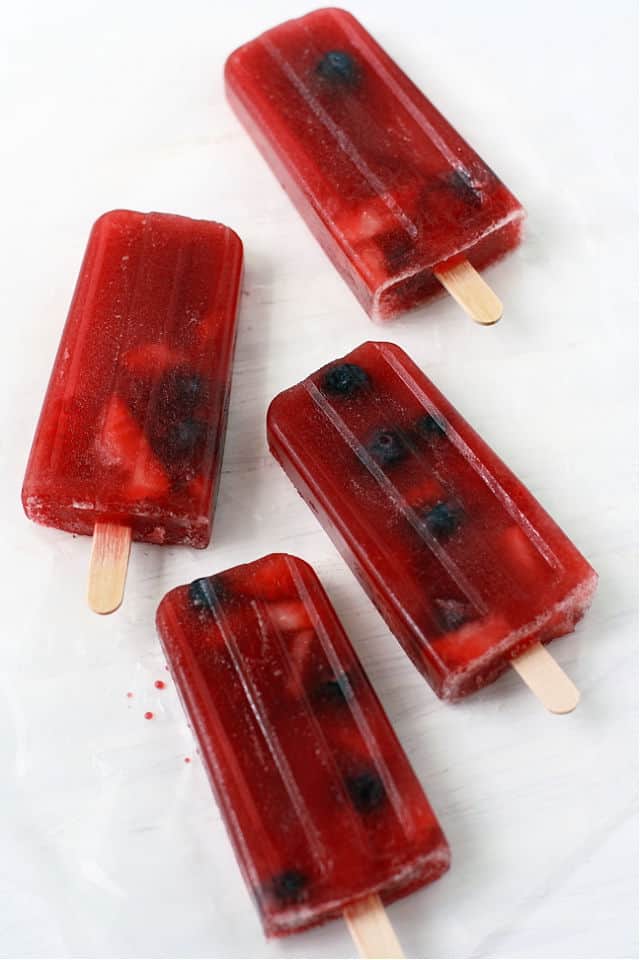 berry tea popsicles on a white background