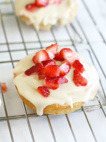 Soft vanilla donuts are topped with rich buttercream and strawberries for a sweet treat!