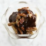 A thick layer of coconut rum hot fudge and salty, sugary pecans make this sundae a special dessert.