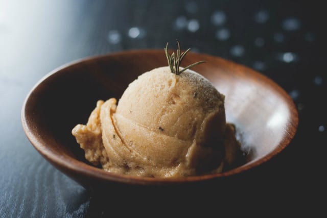 peach sorbet in a wooden bowl