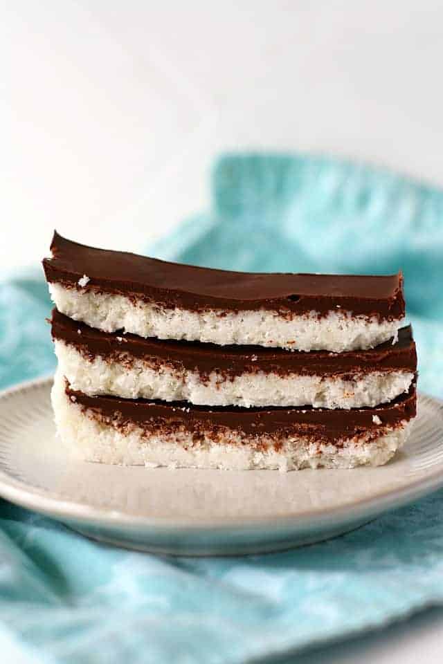 chocolate covered coconut bars on a white plate