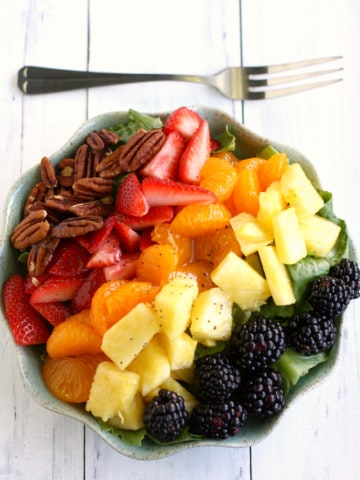 A fresh and delicious salad with a rainbow of fruits, pecans, and a poppy seed dressing. Inspired by Panera's salad, this version is easy to make at home!