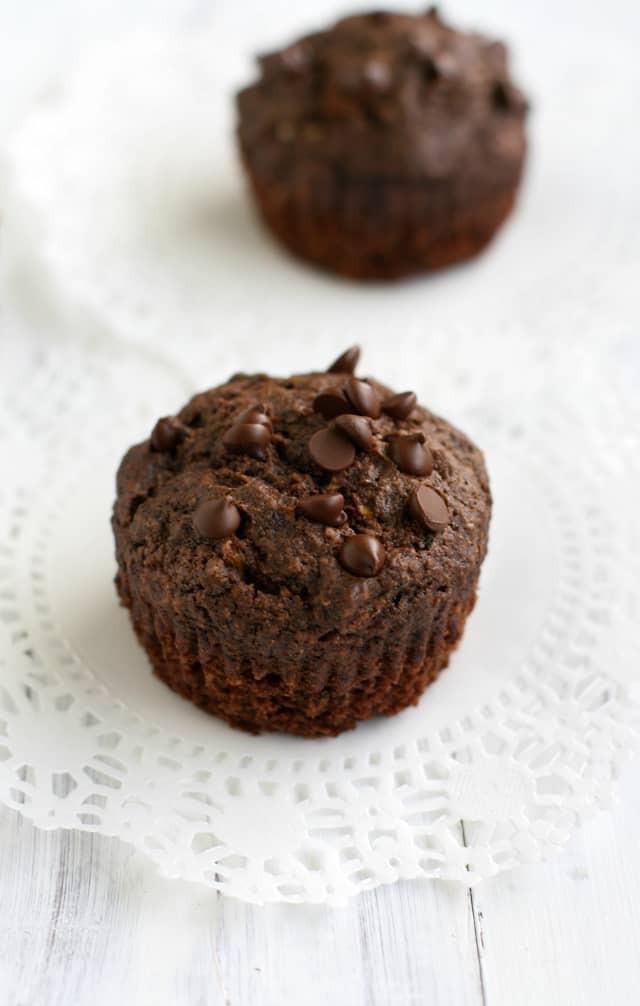 double chocolate zucchini muffins on a white doily