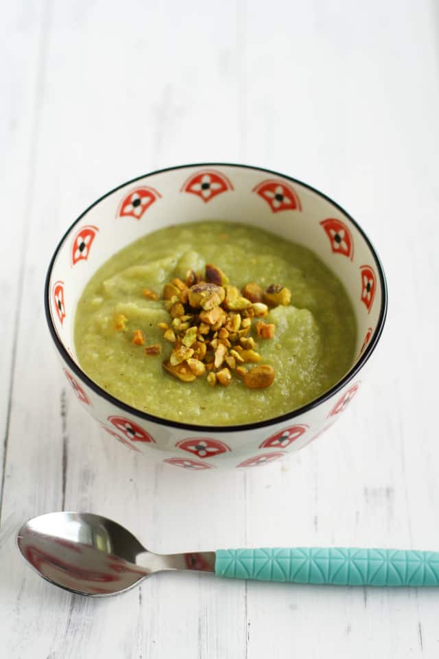 romanesco soup in a white and red bowl