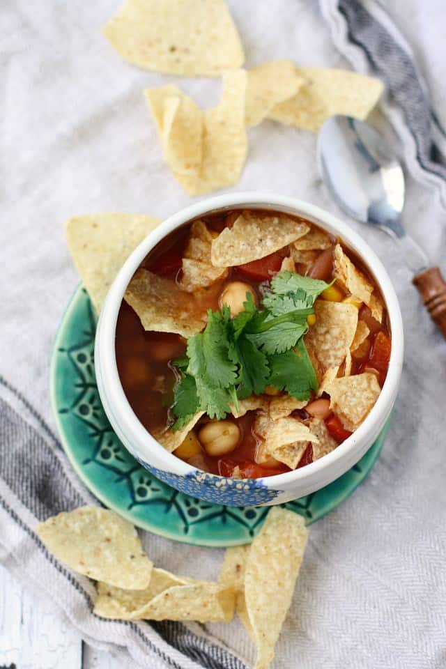 tortilla soup in a white bowl on a green plate