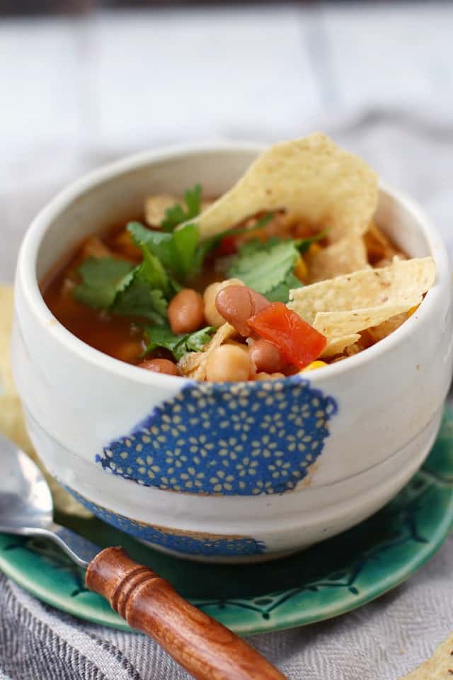 vegan bean tortilla soup in a white and blue bowl