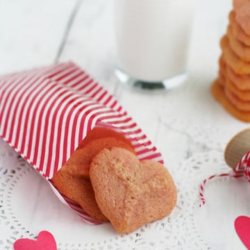 Pink heart cookies made with the cookie press! These buttery spritz cookies are sure to be a favorite!