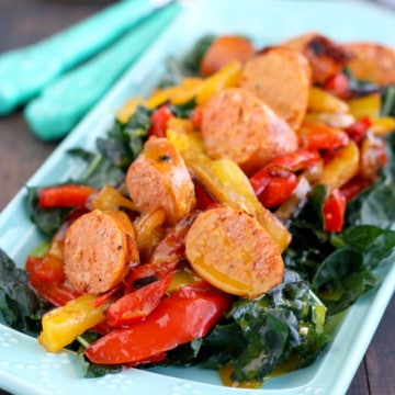 Kale salad with sausages, peppers, and a honey mustard dressing. Delicious and healthy!