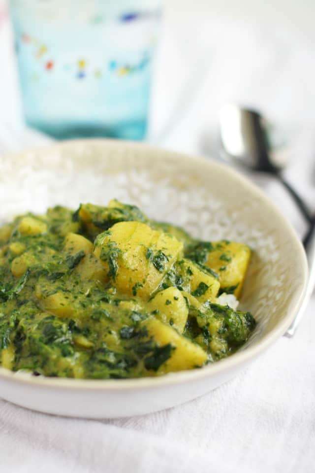 An easy and flavorful Indian curry with yellow potatoes, onions, and spinach. 