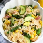 pasta with asparagus and zucchini in a white bowl