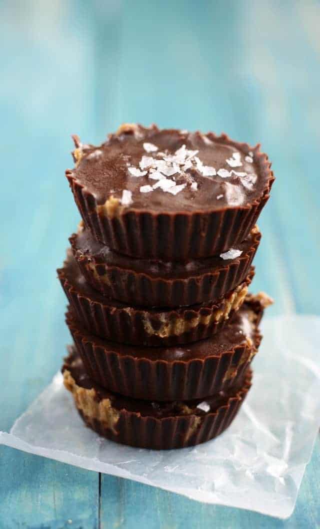 stack of dairy free salted chocolate sunbutter cups on waxed paper