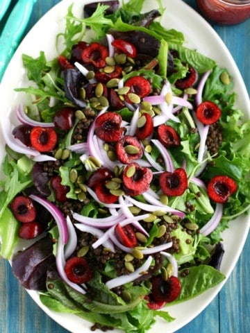 Fresh and healthy salad topped with cherries, lentils, and a cherry vinaigrette - the perfect summer recipe!
