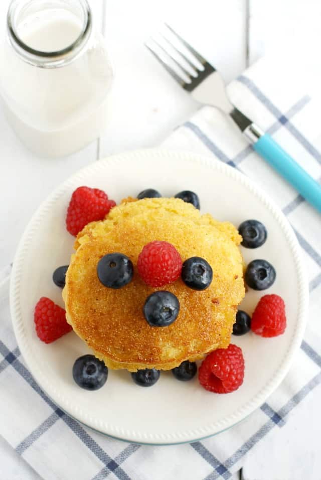 vegan cornmeal pancakes with blueberries on top