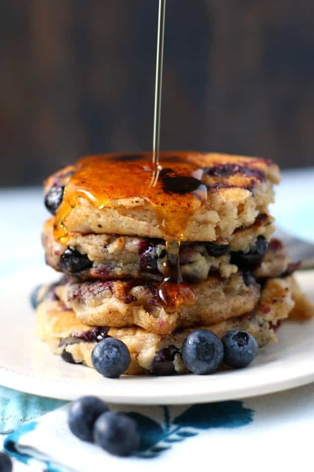 blueberry oatmeal pancakes on a plate with maple syrup