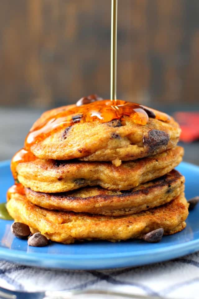 vegan pumpkin pancakes with syrup being poured