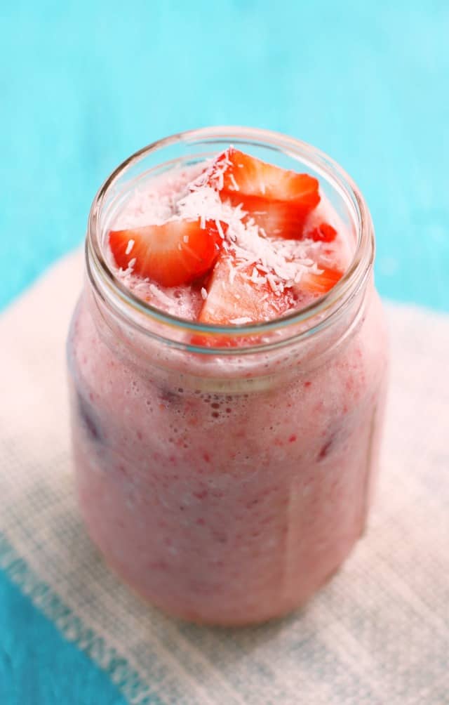 strawberry smoothie in a mason jar on a burlap napkin