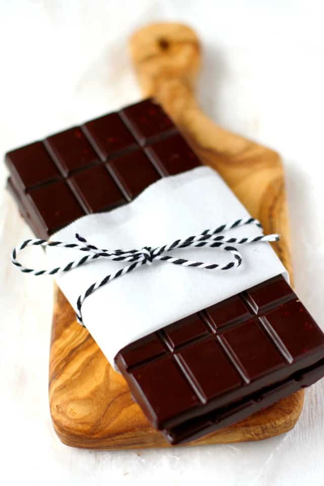 candy bars wrapped in paper and twine on a cutting board