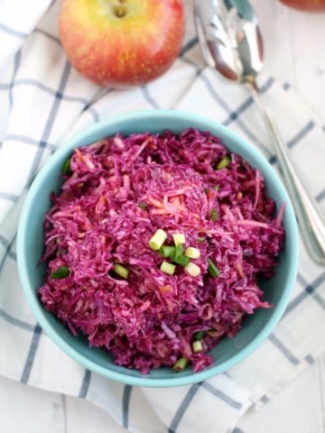 Simple red cabbage slaw with apples is sweet and tangy, and a terrific side dish!