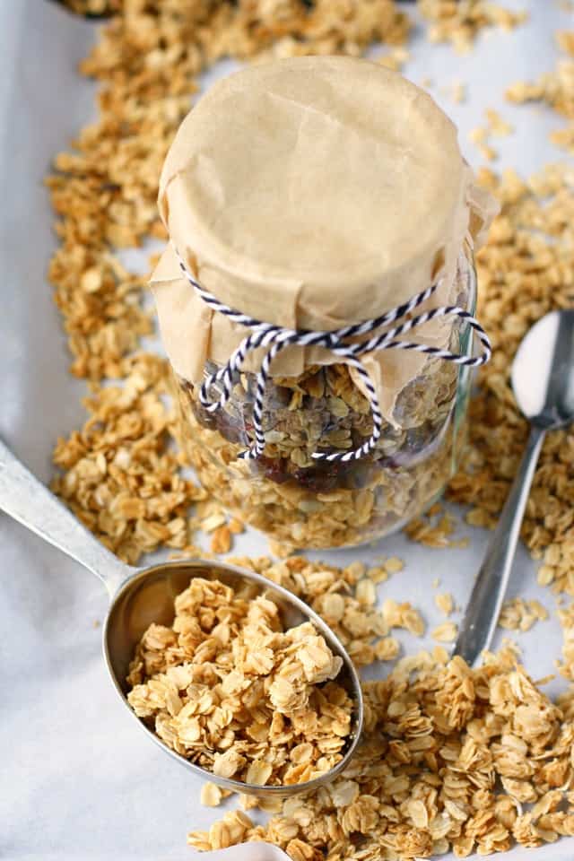 scoop of gluten free granola near a mason jar tied with twine