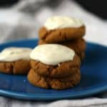 frosted molasses cookies on a blue plate