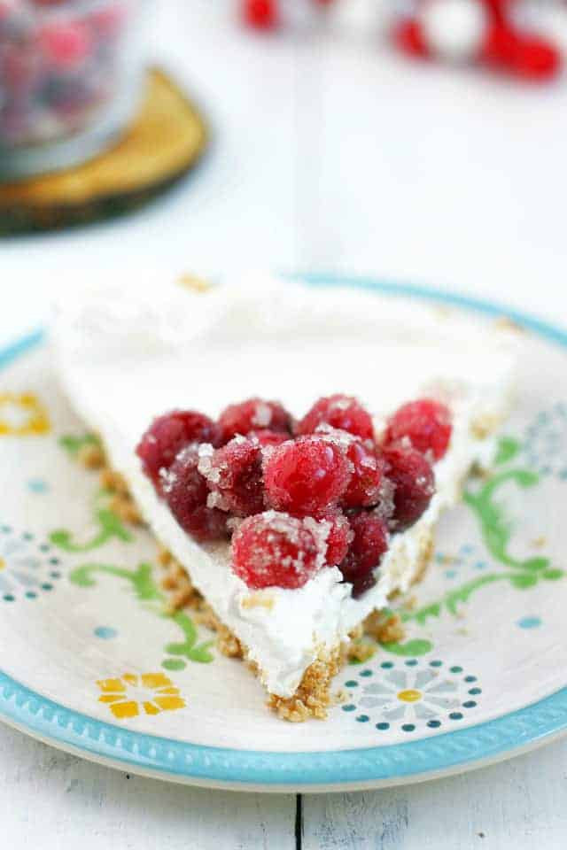 slice of dairy free cheesecake with cranberries on a plate