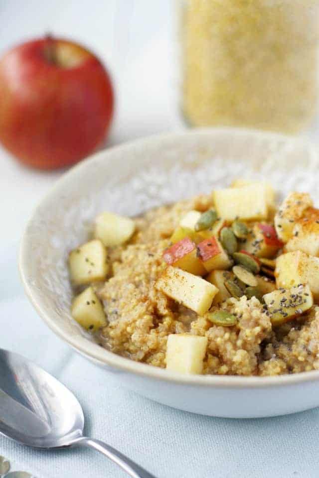 Gluten free millet porridge is topped with a cinnamon apple topping. The perfect cozy breakfast for winter.