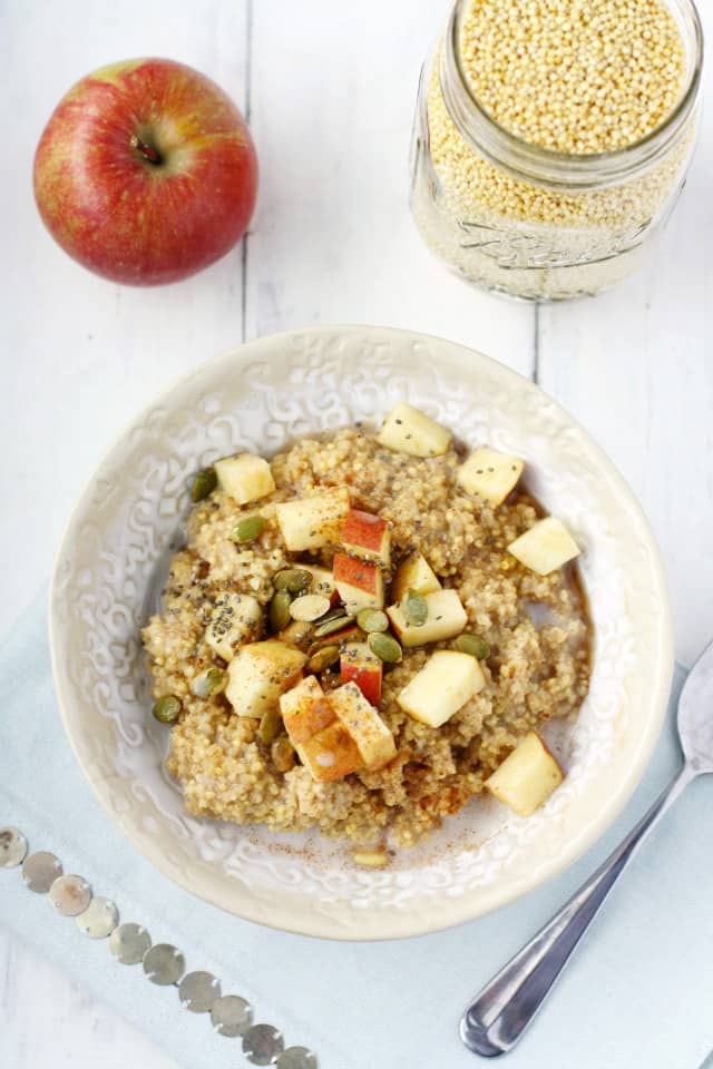 millet breakfast porridge with chopped apples in a white bowl