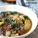 Lentil, sausage, potato, and kale soup made in the slow cooker! Healthy comfort food for winter.