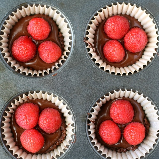 no-bake chocolate raspberry tarts in a cupcake pan