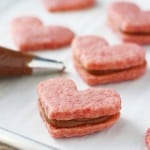 Naturally pink gluten free sugar cookies are filled with a rich chocolate creme. These heart shaped cookies are just right for Valentine's Day! #glutenfree ad #vegan #top8free