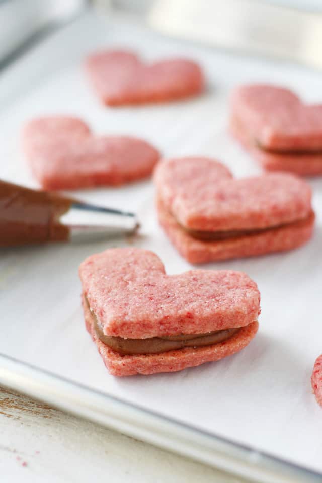 Naturally pink gluten free sugar cookies are filled with a rich chocolate creme. These heart shaped cookies are just right for Valentine's Day! #glutenfree ad #vegan #top8free