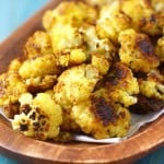 My FAVORITE way to eat cauliflower! Curried roasted garlic cauliflower is easy, healhty, and spicy!
