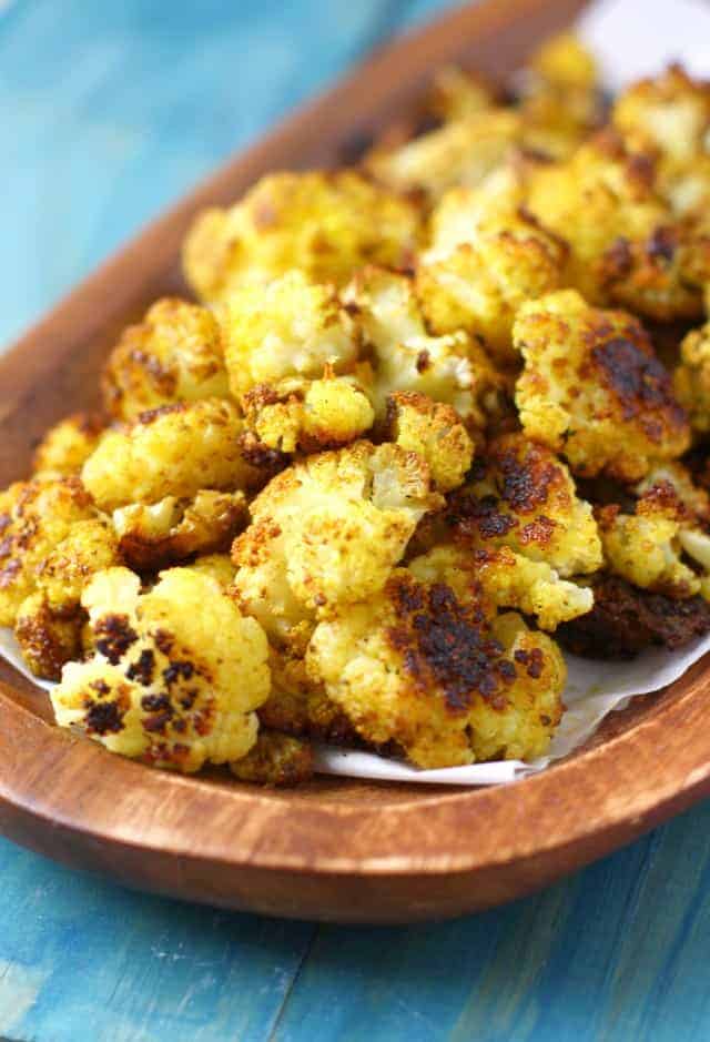 My FAVORITE way to eat cauliflower! Roasted garlic curried cauliflower is easy, healhty, and spicy!