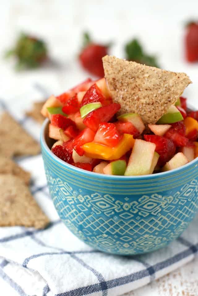 vegan fruit salsa in a blue bowl on a white and blue napkin