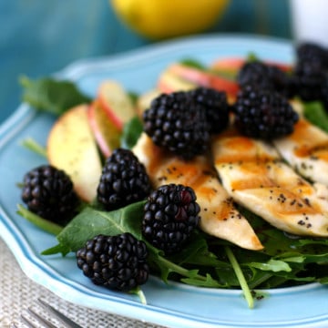 A fresh green salad topped with blackberries, apples, chicken, and a lemon poppy seed dressing. So delicious for spring! #ad