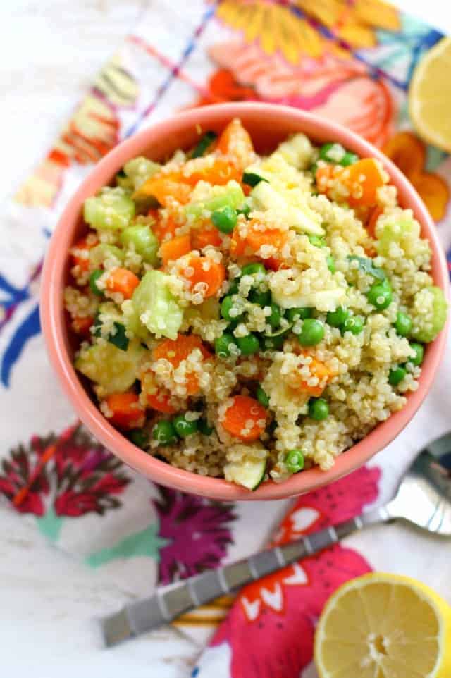 vegan quinoa salad with zucchini in a pink bowl
