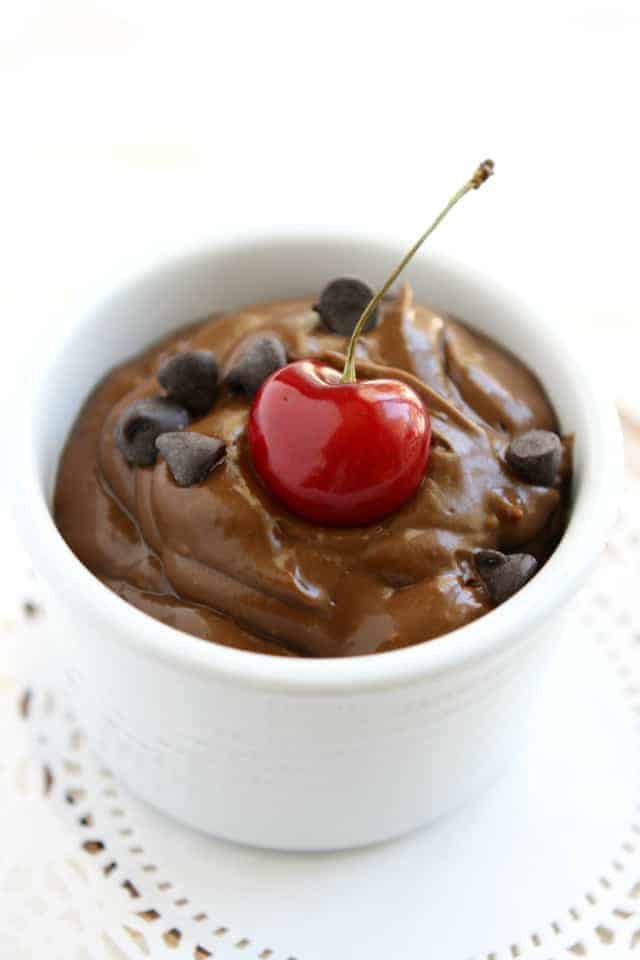 chocolate avocado mousse with a cherry and chocolate chips
