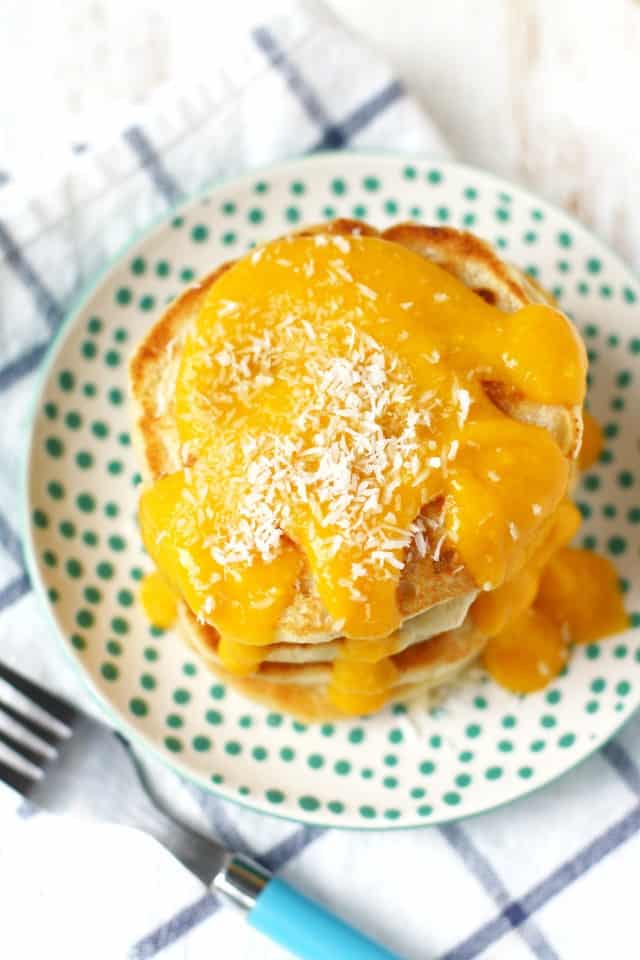 vegan coconut pancakes with mango sauce on a plate with a fork