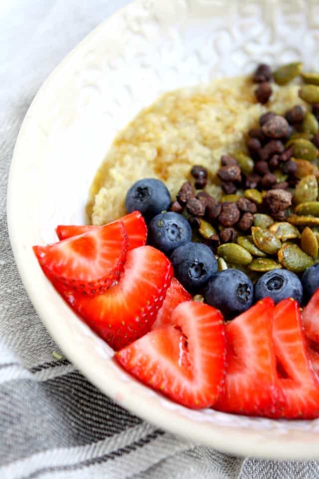 berries and maple syrup on quinoa porridge