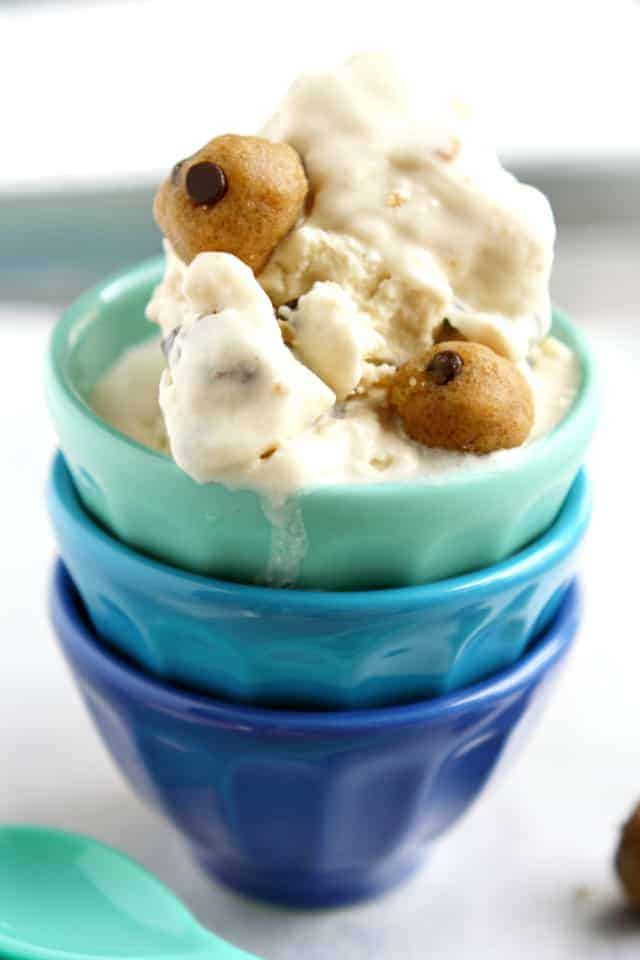 vegan cookie dough ice cream in a stack of blue ceramic bowls