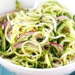 A fresh summer salad made with zucchini noodles and red onion! Delicious and healthy!