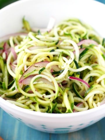 A fresh summer salad made with zucchini noodles and red onion! Delicious and healthy!